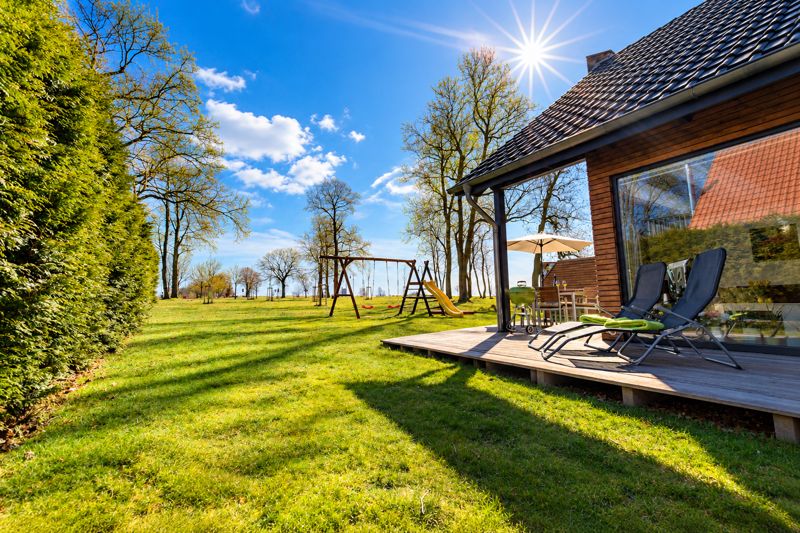 Garden with sun loungers, swings and slide
