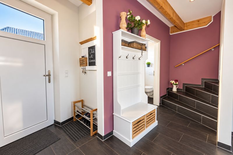 Entrance hall in Thea with coat stand and stairs