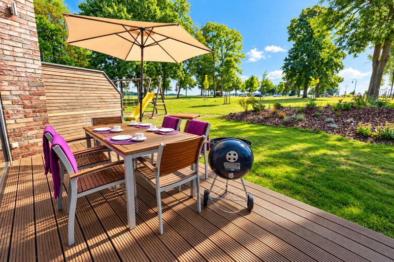 Thea's terrace laid for breakfast, with grill and garden view